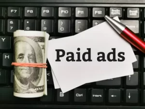Image illustrating a scale with "Organic Results" on one side and "Paid Ads" on the other, symbolizing the equilibrium in content promotion approaches.